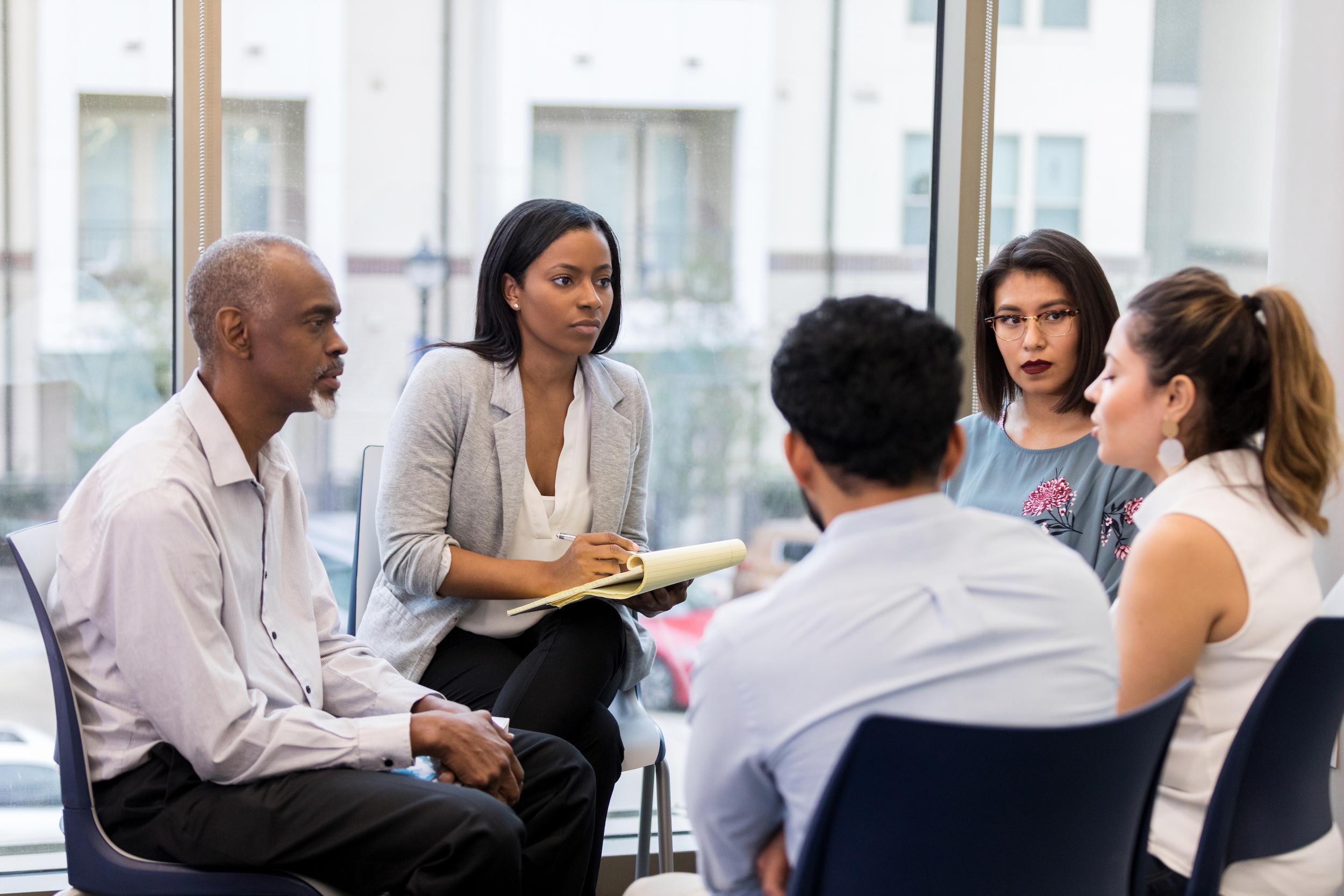 woman listening at team building meeting